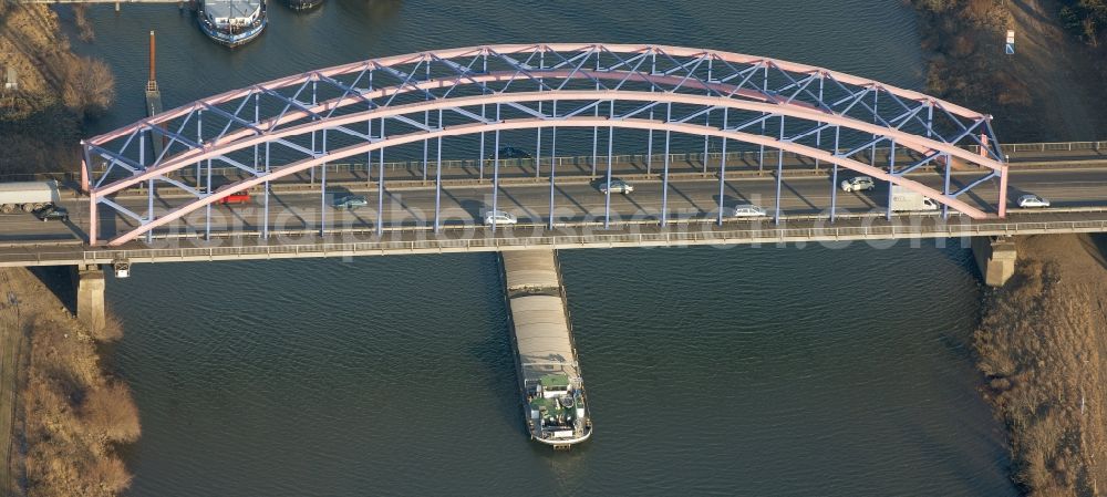 Duisburg from the bird's eye view: Karl-Lehr-bridge over the Ruhr in Duisburg in Nordrhein-Westfalen. The carriers of the arch bridge are made of steel. In the center of the image a cargo ship crossing the bridge on the Ruhr