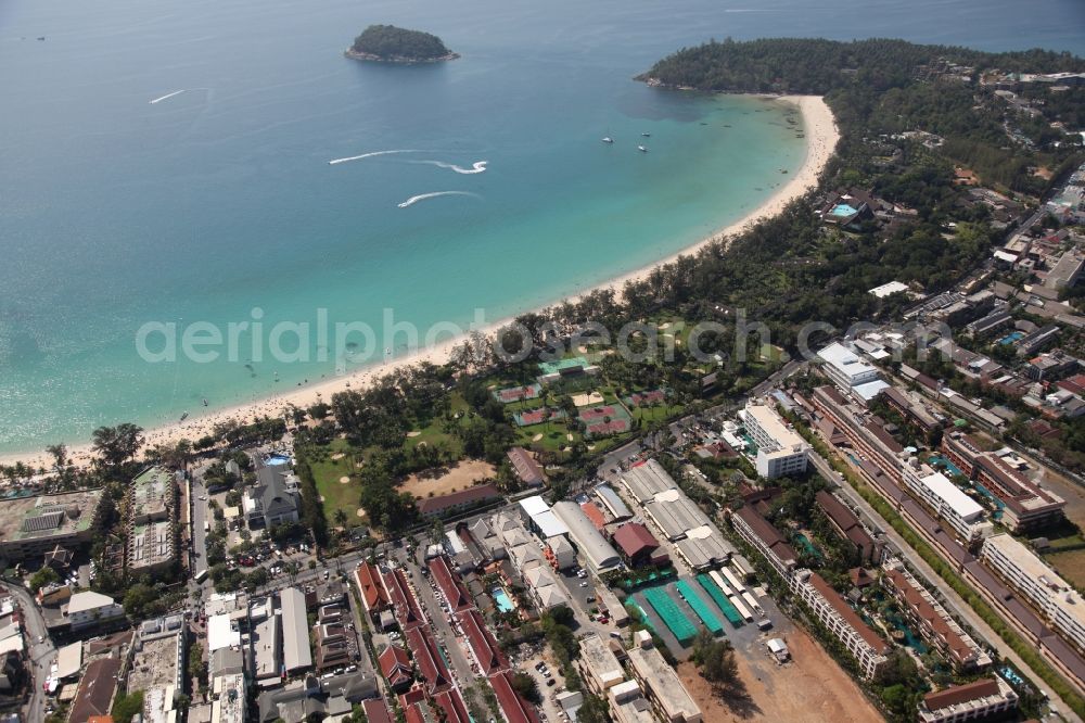 Aerial image Karon - The Kata Beach in front of the city Karon on the island of Phuket in Thailand is a sandy beach with a island in front. Between the beach and the town are hotels, sports facilities and green areas