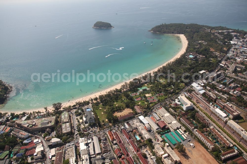 Aerial photograph Karon - The Kata Beach in front of the city Karon on the island of Phuket in Thailand is a sandy beach with a island in front. Between the beach and the town are hotels, sports facilities and green areas