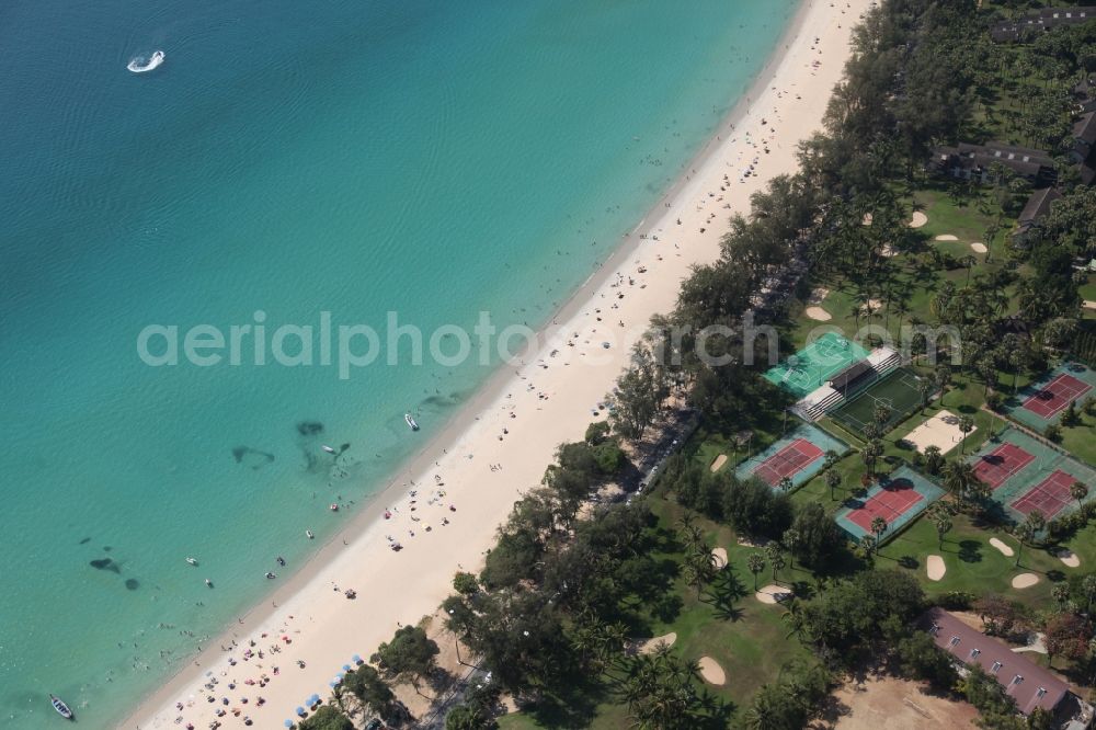 Karon from above - The Kata Beach in front of the city Karon on the island of Phuket in Thailand is a sandy beach with a island in front. Between the beach and the town are hotels, sports facilities and green areas