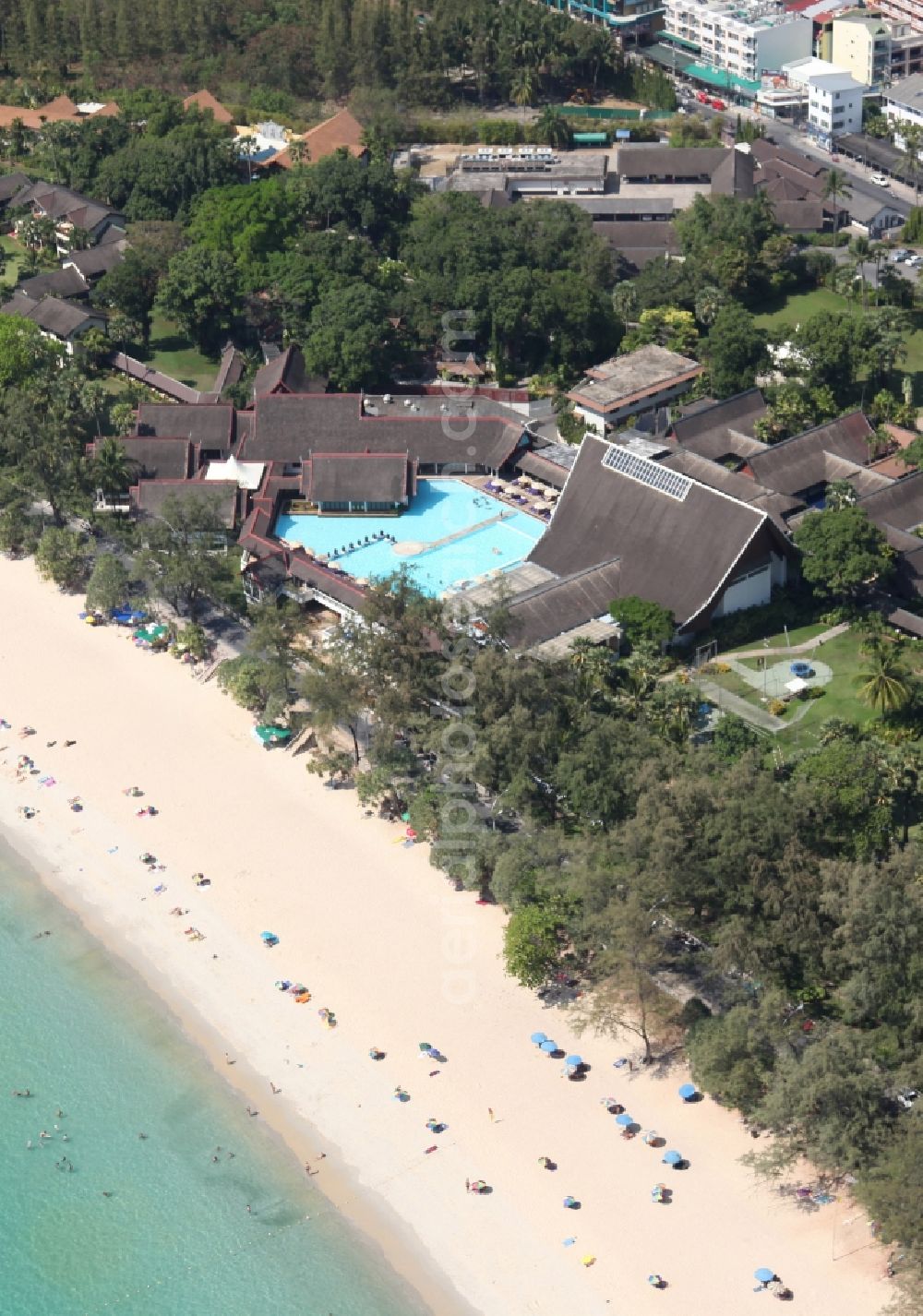 Karon from above - The Kata Beach in front of the city Karon on the island of Phuket in Thailand is a sandy beach with a island in front. Between the beach and the town are hotels, sports facilities and green areas