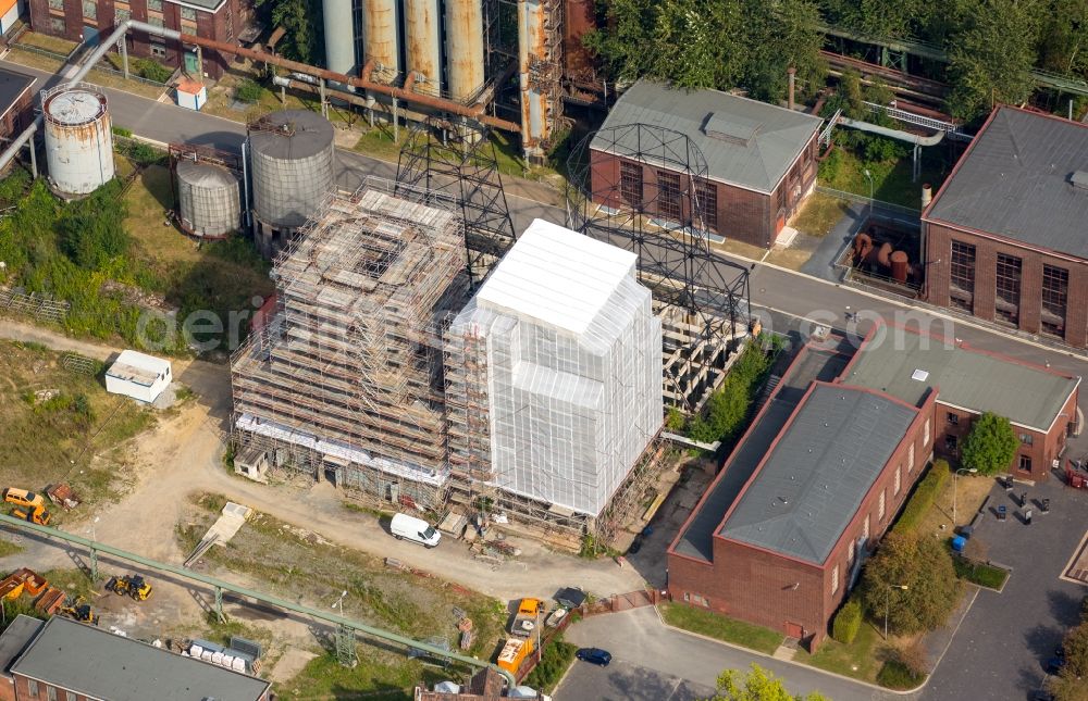 Dortmund from the bird's eye view: Cooling tower restoration on the area of the stockpile of the coking plant Hanse in Dortmund-Huckarde in the federal state North Rhine-Westphalia. The museum coking plant Hanse contains extensive technical arrangements like the uncompleted gasometre