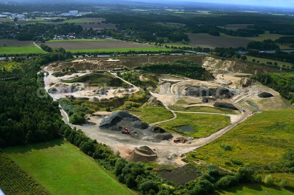 Aerial photograph Dibbersen - Site and tailings area of the gravel mining on motorway BAB A1 in Dibbersen in the state Lower Saxony, Germany