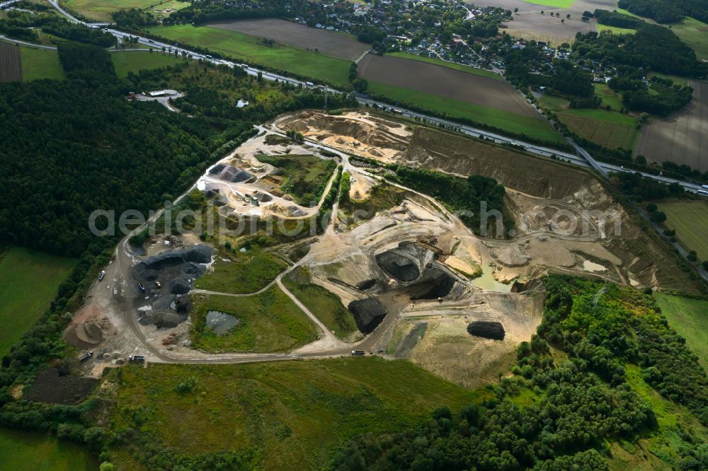 Dibbersen from above - Site and tailings area of the gravel mining on motorway BAB A1 in Dibbersen in the state Lower Saxony, Germany