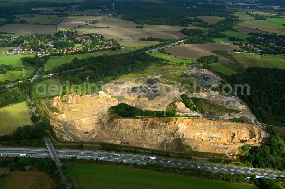 Aerial photograph Dibbersen - Site and tailings area of the gravel mining on motorway BAB A1 in Dibbersen in the state Lower Saxony, Germany