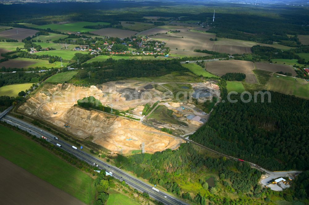 Dibbersen from above - Site and tailings area of the gravel mining on motorway BAB A1 in Dibbersen in the state Lower Saxony, Germany