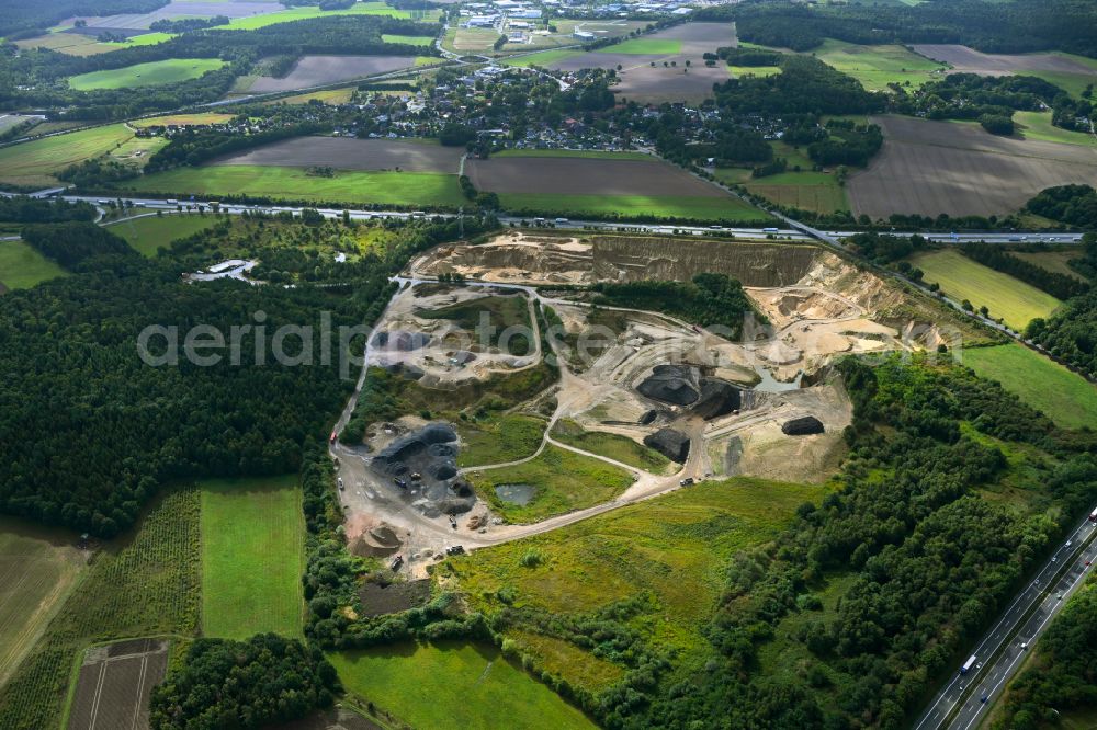 Aerial photograph Dibbersen - Site and tailings area of the gravel mining on motorway BAB A1 in Dibbersen in the state Lower Saxony, Germany