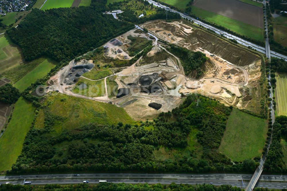 Dibbersen from above - Site and tailings area of the gravel mining on motorway BAB A1 in Dibbersen in the state Lower Saxony, Germany