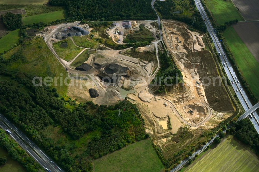 Dibbersen from the bird's eye view: Site and tailings area of the gravel mining on motorway BAB A1 in Dibbersen in the state Lower Saxony, Germany