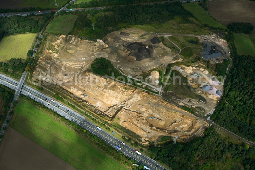 Dibbersen from above - Site and tailings area of the gravel mining on motorway BAB A1 in Dibbersen in the state Lower Saxony, Germany