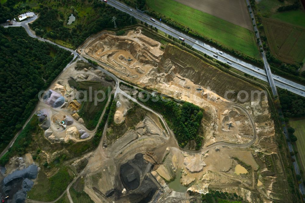 Dibbersen from the bird's eye view: Site and tailings area of the gravel mining on motorway BAB A1 in Dibbersen in the state Lower Saxony, Germany