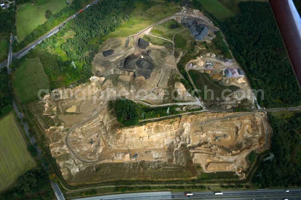 Aerial photograph Dibbersen - Site and tailings area of the gravel mining on motorway BAB A1 in Dibbersen in the state Lower Saxony, Germany