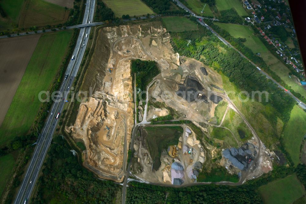 Dibbersen from above - Site and tailings area of the gravel mining on motorway BAB A1 in Dibbersen in the state Lower Saxony, Germany