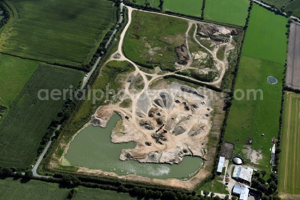 Oeversee from the bird's eye view: Site and tailings area of the gravel mining of the Gonde Clausen Kies- und Betonwerk Oeversee GmbH at the Sankelmarker lake in Oeversee in the state Schleswig-Holstein