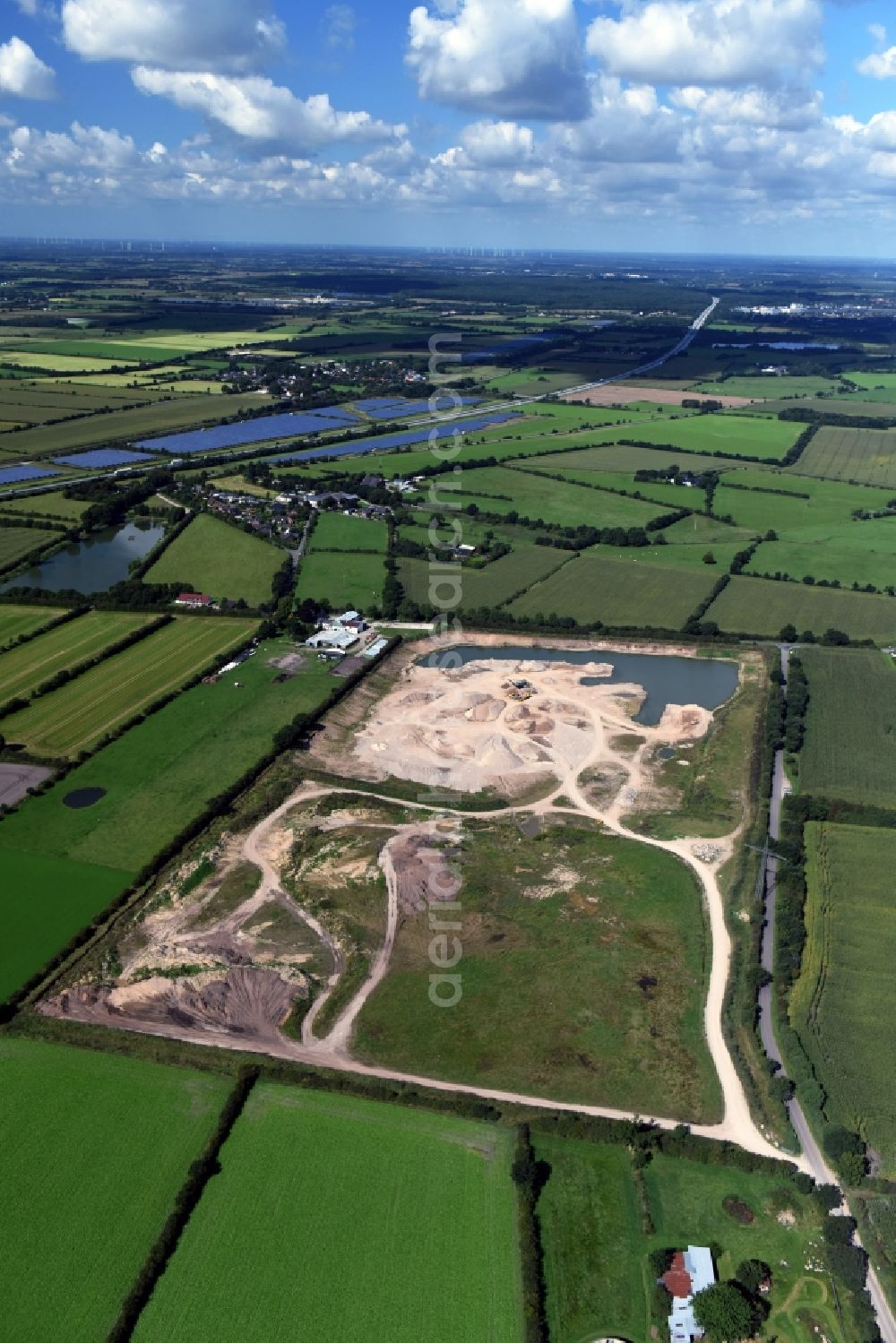 Oeversee from the bird's eye view: Site and tailings area of the gravel mining of the Gonde Clausen Kies- und Betonwerk Oeversee GmbH at the Sankelmarker lake in Oeversee in the state Schleswig-Holstein