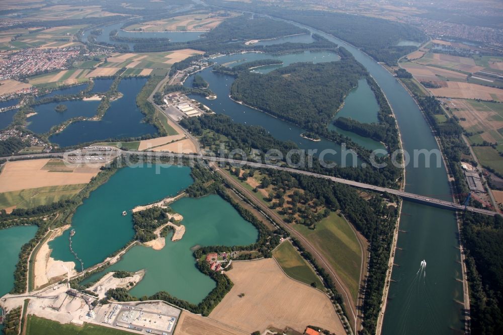 Speyer from above - Site and tailings area of the gravel mining im See Deutschewuehl in Speyer in the state Rhineland-Palatinate. The quarry and the other lakes have emerged from earlier Rhein loops after it has been straightened 