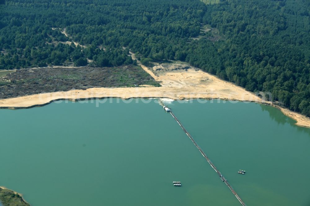 Spreenhagen from the bird's eye view: Site and tailings area of the gravel mining lake in Spreenhagen in the state Brandenburg