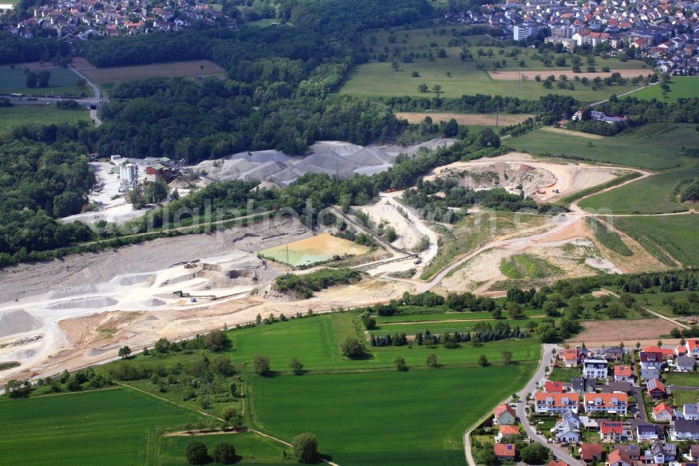 Aerial photograph Weil am Rhein - Gravel pit on the mining site in Weil am Rhein in the state of Baden-Wuerttemberg. The mining permit for the gravel plant runs out, reclamation activities are necessary and a gravel biotope will emerge