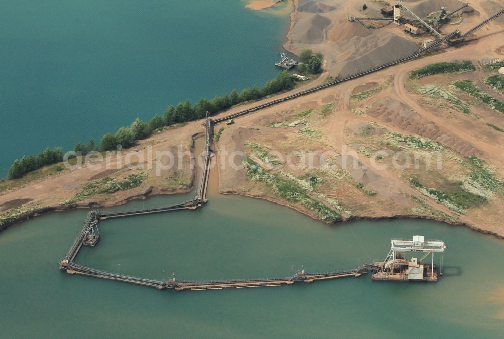 Aerial image Nordhausen - The Sundhaeuser Lake and nearby lakes near Nordhausen in Thuringia are used among other things for gravel mining. Heavy equipment dredged gravel from below the water surface and transports it to the screen