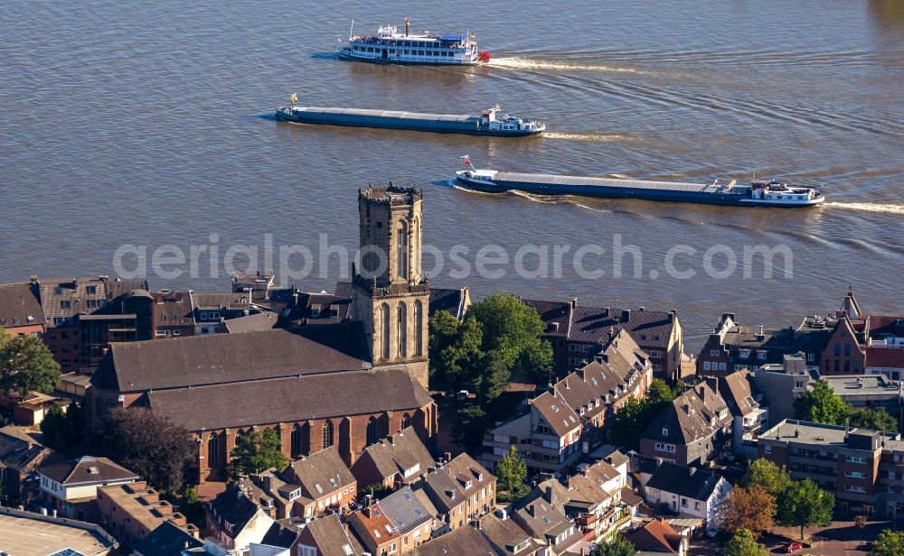 Aerial image Emmerich - Church St. Aldegundis overlooking the river Rhine with cargo ships in Emmerich in North Rhine-Westphalia