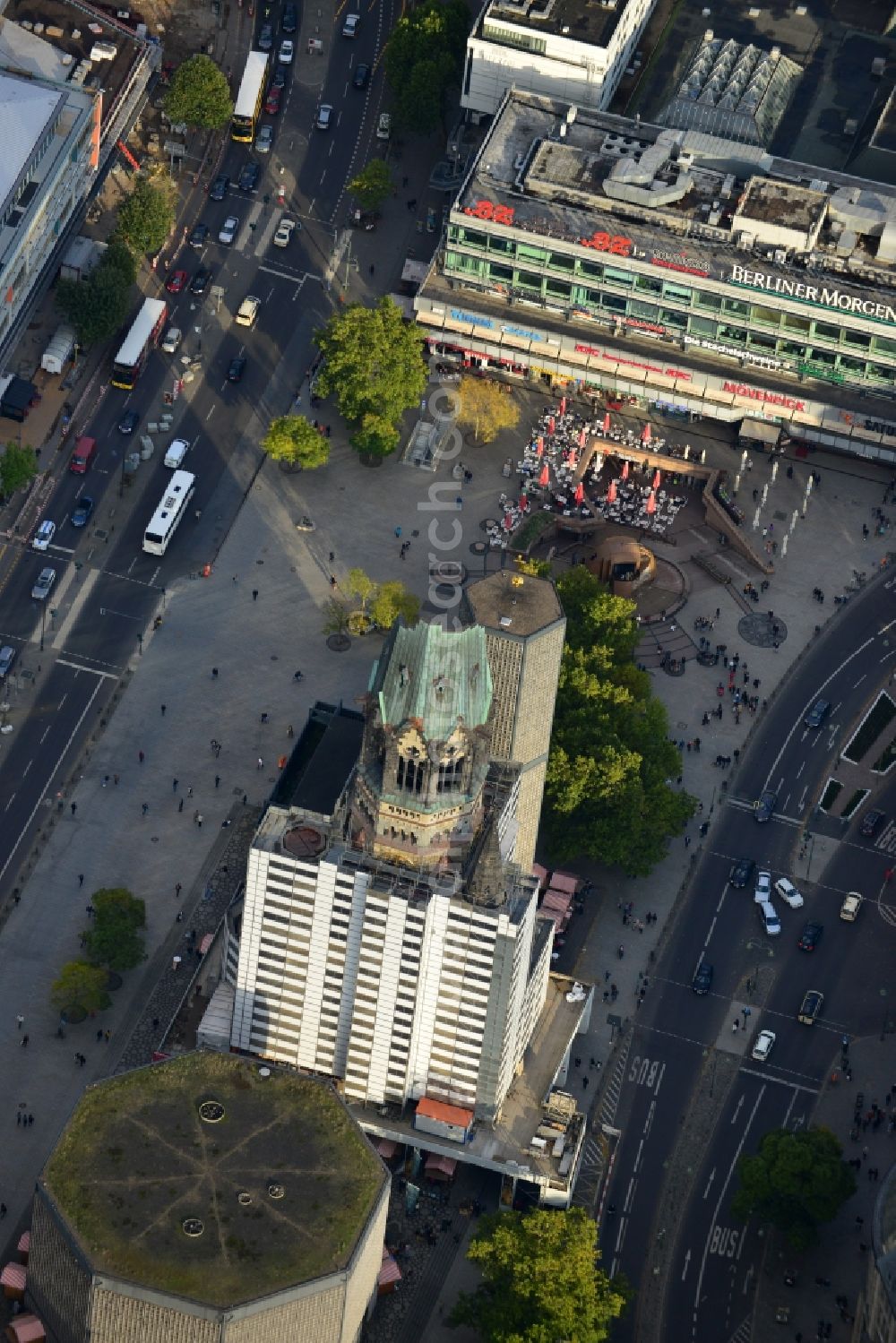 Berlin from the bird's eye view: The Protestant Kaiser William Memorial Church, commonly short memorial church stands on the Breitscheidplatz between the Kurfürstendamm, the Tauentzienstraße and the Budapest street in Berlin's Charlottenburg district. The non-damaged part of the old church is now a museum and war memorial