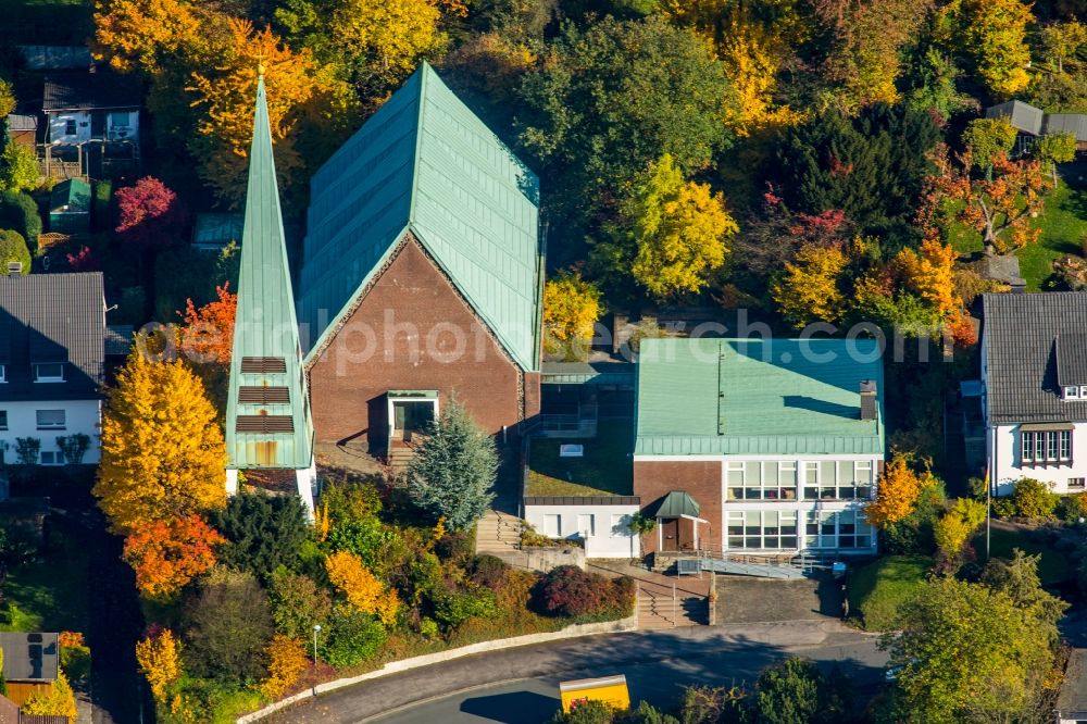 Arnsberg from the bird's eye view: Church building of the protestant redeemer church on a autumnal forest in Arnsberg in the state of North Rhine-Westphalia