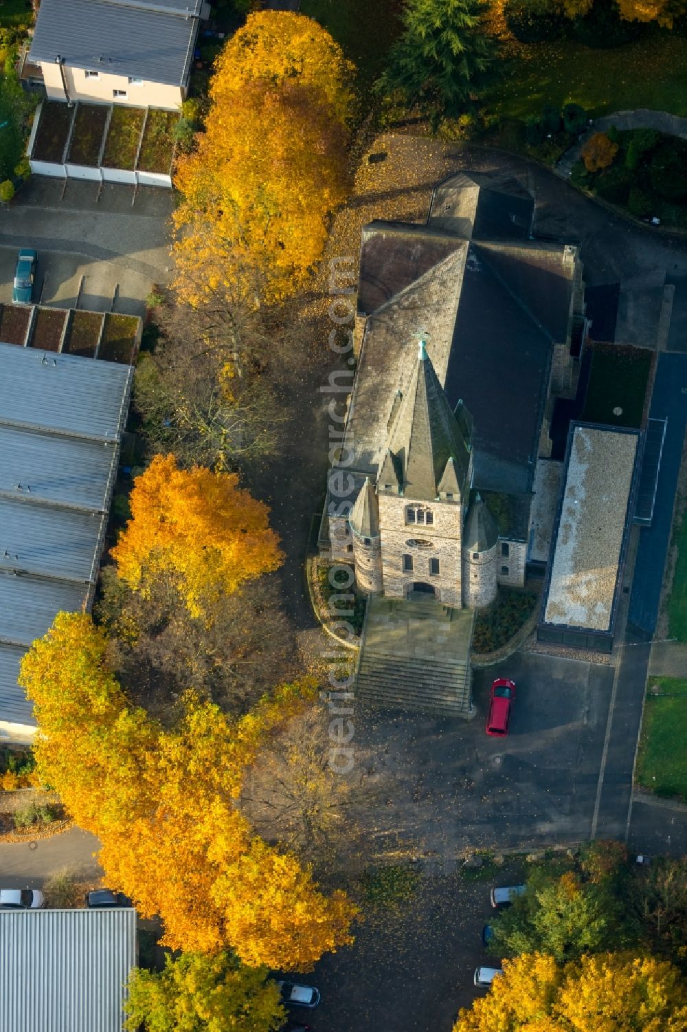 Witten from above - Church building of the protestant church Bommern in Witten in the state of North Rhine-Westphalia. The church is located amidst autumnal colourful trees in a residential area