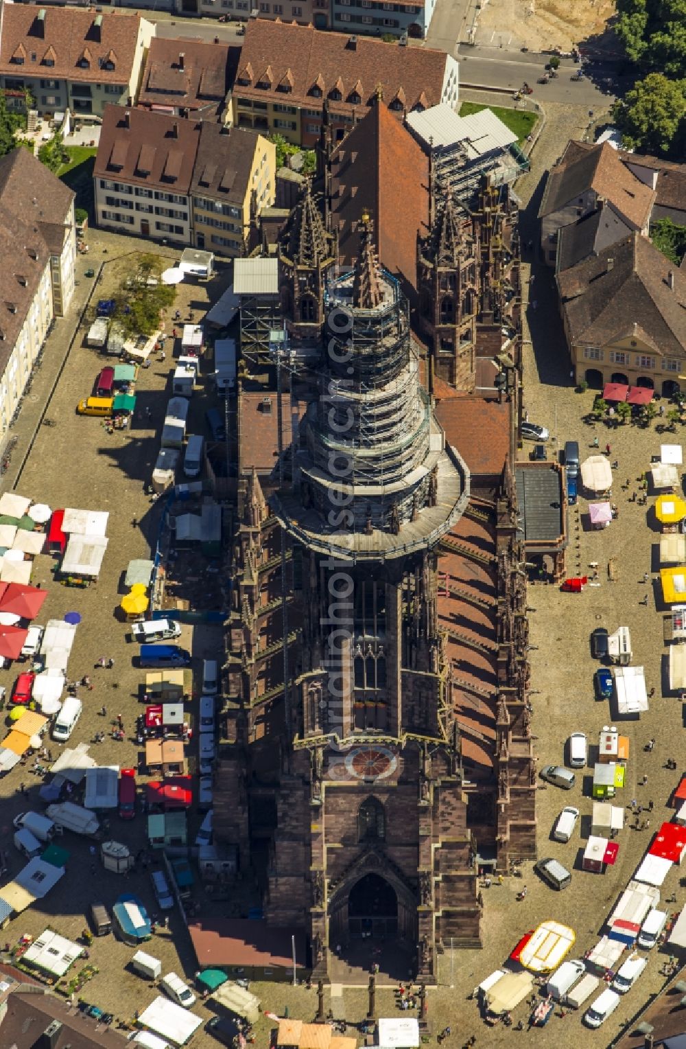 Freiburg im Breisgau from above - Church building of the Freiburg Muenster Cathedral Square in the old town of Freiburg in Baden-Wuerttemberg. freiburgermuenster.info