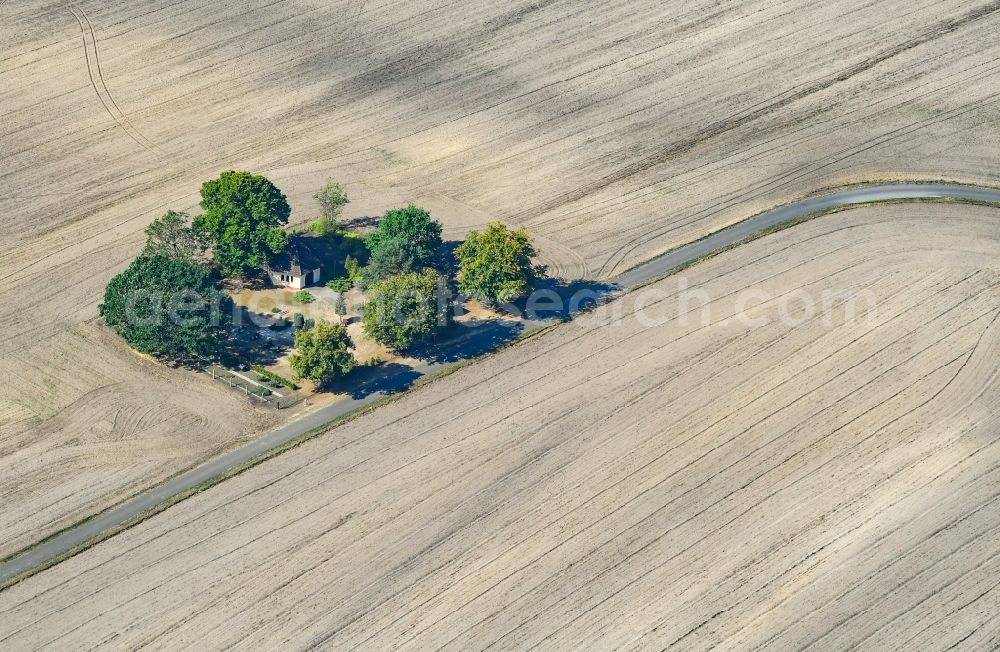 Radensdorf from the bird's eye view: Churches building the chapel in plowed field landscape in Radensdorf in the state Brandenburg, Germany