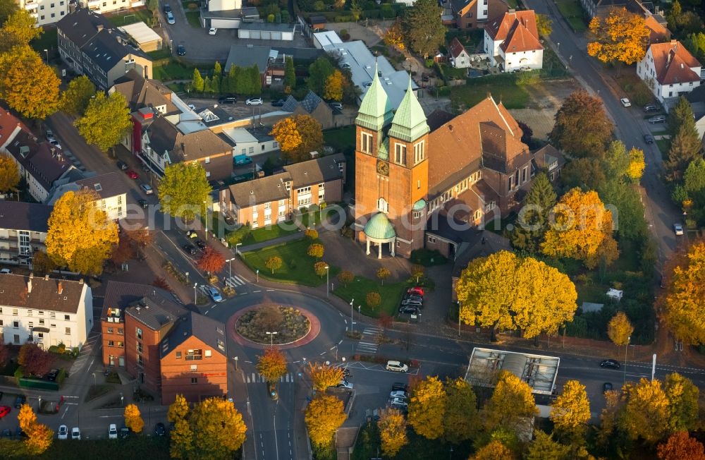 Aerial photograph Gladbeck - Church building of the Herz Jesu church community on Kardinal-Hengsbach Square in autumnal Gladbeck in the state of North Rhine-Westphalia