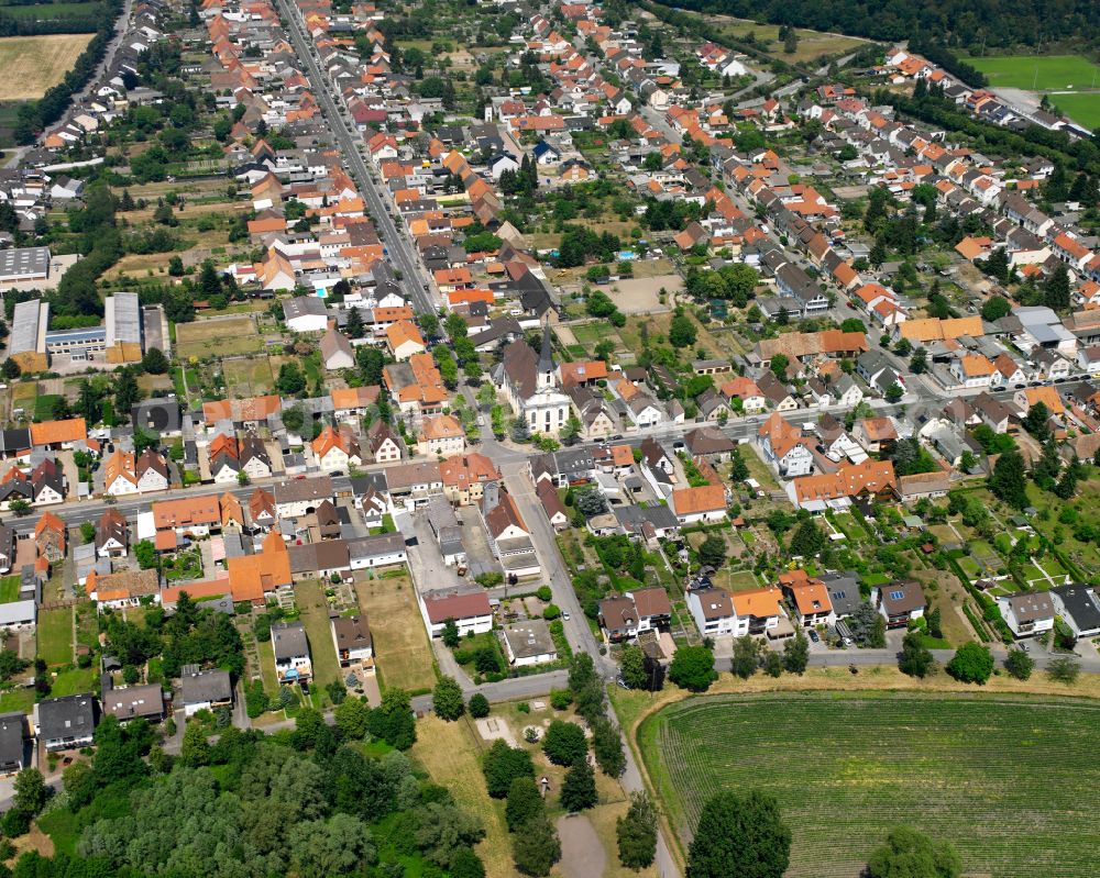 Aerial image Philippsburg - Church building of Pfarrkirche St. Peter Huttenheim on street Rheinstrasse in residential area in the district Huttenheim in Philippsburg in the state Baden-Wuerttemberg, Germany