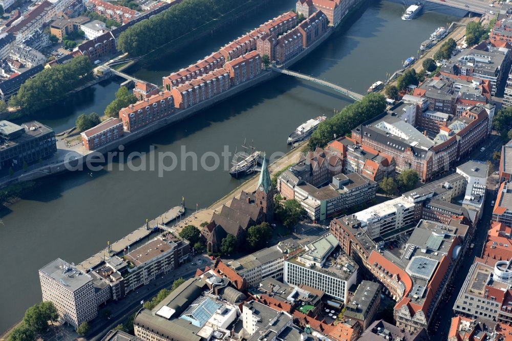 Bremen from the bird's eye view: Church building of Sankt Martini on the riverbank of the Weser in the historic town centre of Bremen in Germany. The historic Teerhof peninsula is visible opposite the church