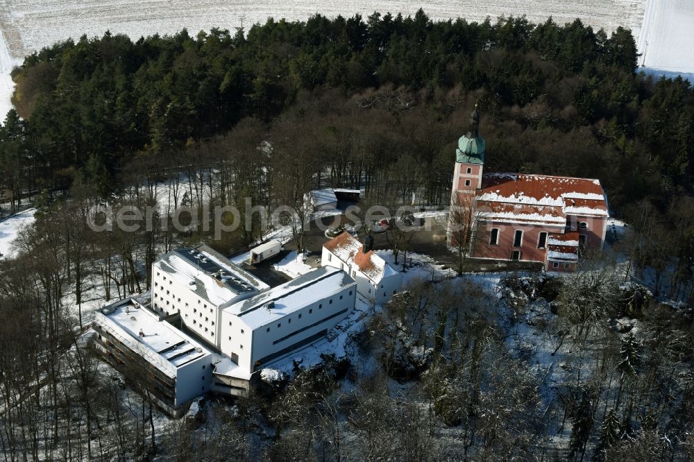 Velburg from above - Wintry snowy Church building on Wallfahrt- und Dioezesanjugendhaus Habsberg in Velburg in the state Bavaria