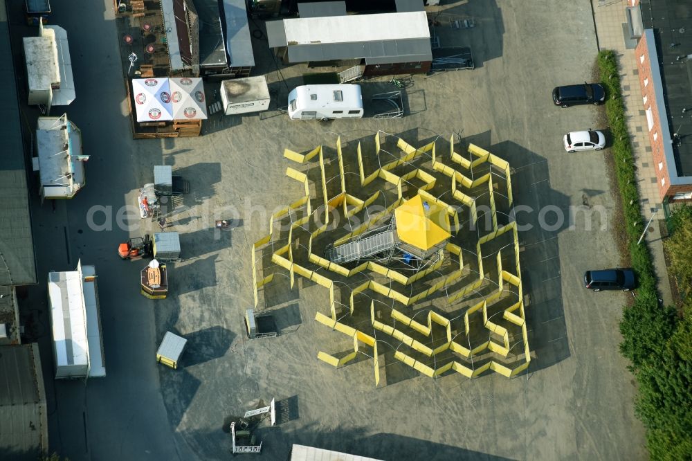 Cloppenburg from the bird's eye view: Fair - event location at festival with yellow labyrinth and maze in Cloppenburg in the state Lower Saxony