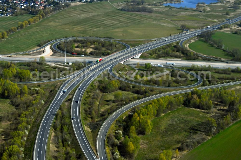 Velten from above - Traffic flow at the intersection- motorway A10 Oranienburger Kreuz in form of cloverleaf in Velten in the state Brandenburg, Germany