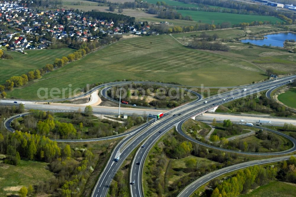 Velten from the bird's eye view: Traffic flow at the intersection- motorway A10 Oranienburger Kreuz in form of cloverleaf in Velten in the state Brandenburg, Germany