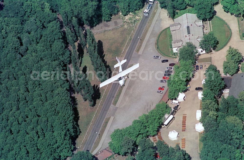 Hoppegarten from the bird's eye view: A small plane circling above the entrance area of the Golopprennbahn Hoppe garden