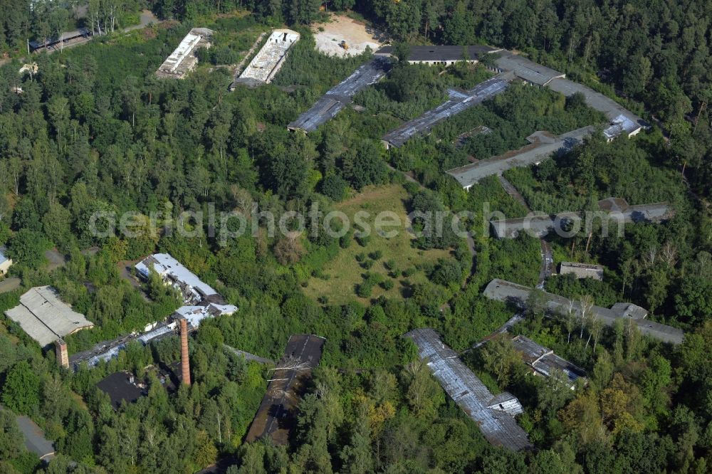 Bad Düben from the bird's eye view: Hospital grounds of the old Waldkrankenhaus in Bad Dueben in the state of Saxony. The historic semi-circular and partly decayed compound with its elongated buildings is located in a forest in the North of the town and used to be known as a specialised orthopaedics clinic in the GDR