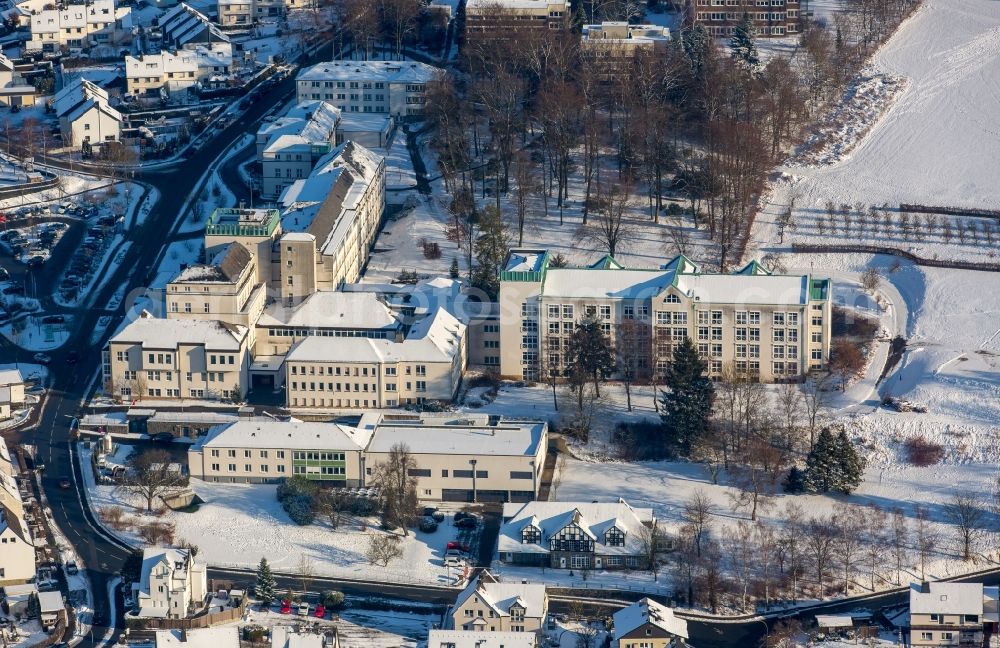 Meschede from above - Winterly snowy view clinic of the hospital grounds St. Walburga-Krankenhaus Meschede GmbH besides the road Schederweg in Meschede in the state North Rhine-Westphalia