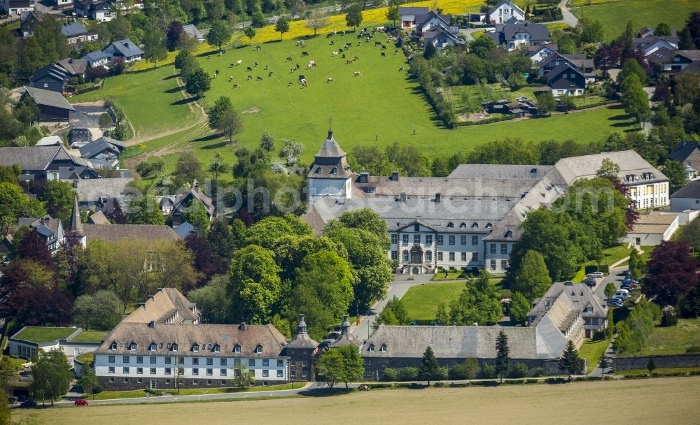 Schmallenberg from above - Grafschaft Monastery in the Grafschaft part of Schmallenberg in the state of North Rhine-Westphalia. The town is located in the county district of Hochsauerland, Grafschaft is located in its East. The large monastery complex consists of parks, a pond, a church and abbey, outbuildings and a gate building