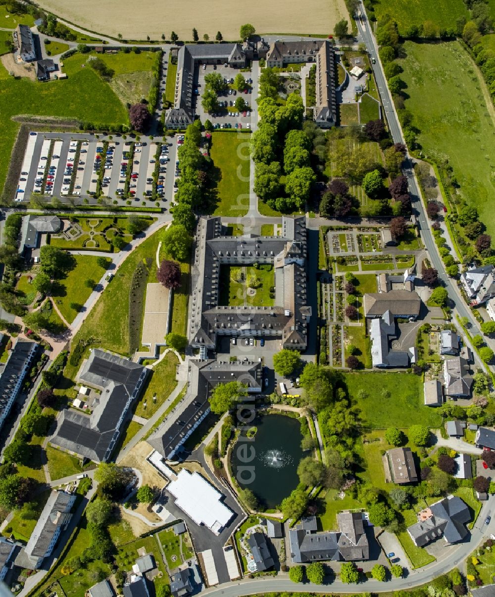 Aerial image Schmallenberg - Grafschaft Monastery in the Grafschaft part of Schmallenberg in the state of North Rhine-Westphalia. The town is located in the county district of Hochsauerland, Grafschaft is located in its East. The large monastery complex consists of parks, a pond, a church and abbey, outbuildings and a gate building