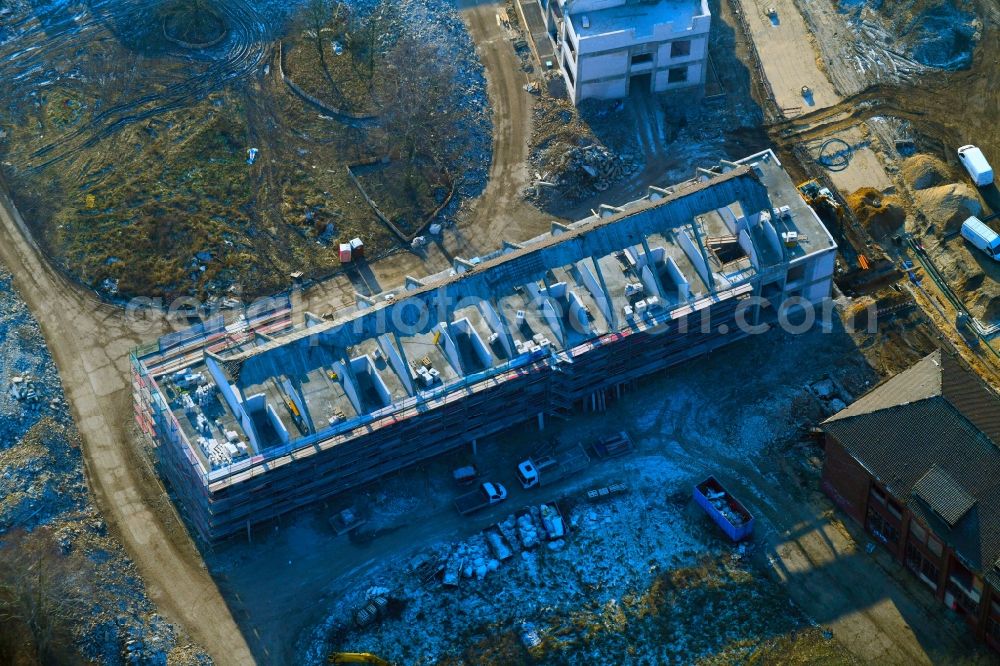 Bernau from the bird's eye view: Construction site for the renovation and reconstruction of the building complex of the former military barracks Sanierungsgebiet Panke-Park on Schoenfelder Weg in Bernau in the state Brandenburg, Germany