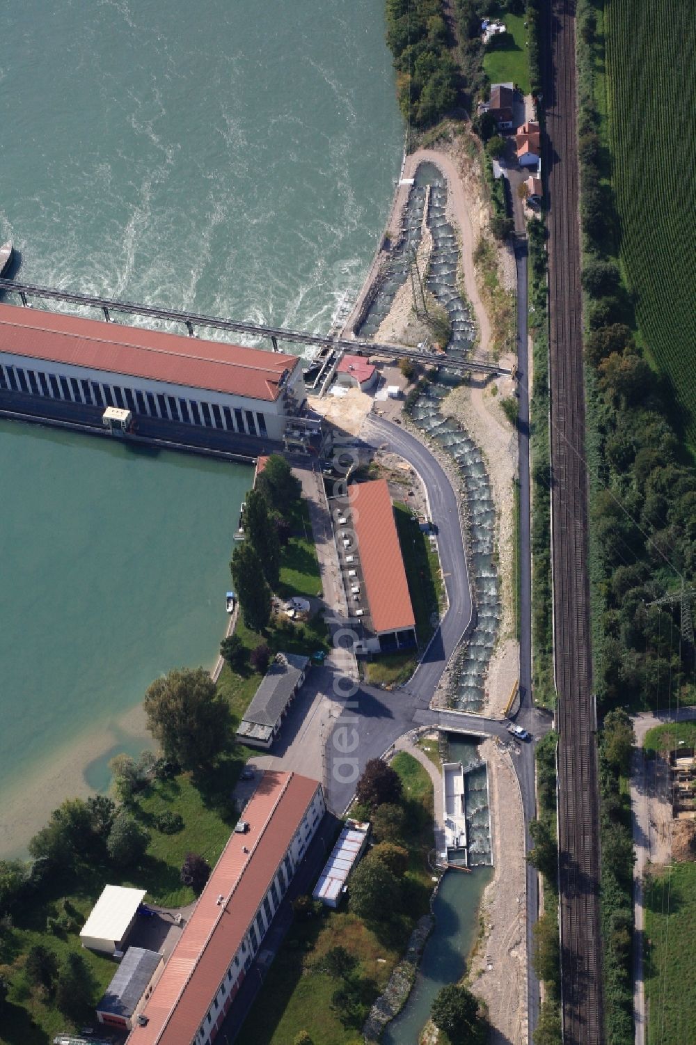 Schwörstadt from the bird's eye view: The water power plant in Schwoerstadt in the state of Baden-Wuerttemberg at the Rhine river with its bypass channel used as fishway. The 1150 meter long fish ladder climbs a height of 9.5 meters between the lower and upper water at the dam