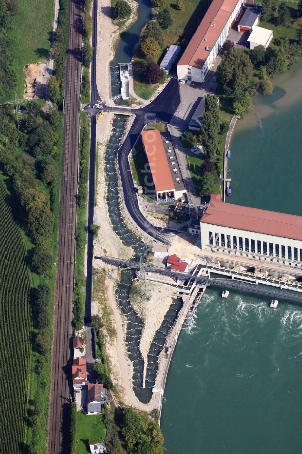 Aerial photograph Schwörstadt - The water power plant in Schwoerstadt in the state of Baden-Wuerttemberg at the Rhine river with its bypass channel used as fishway. The 1150 meter long fish ladder climbs a height of 9.5 meters between the lower and upper water at the dam