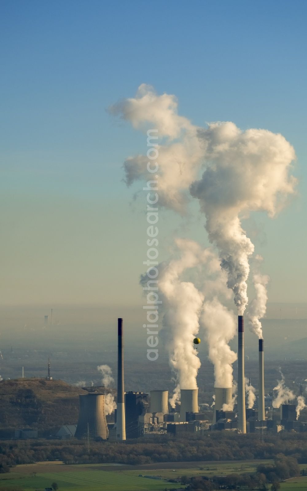 Gelsenkirchen from the bird's eye view: Yellow hot air balloon with the identification D-OWNT in front of the exhaust gas clouds of the power plants and exhaust towers of thermal power station of Uniper Kraftwerke GmbH in the district Gelsenkirchen-Nord in Gelsenkirchen in the state North Rhine-Westphalia