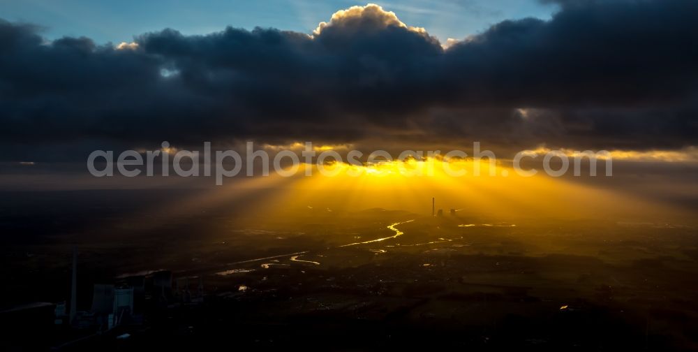 Bergkamen from above - Power plants and exhaust towers of the coal thermal power plant of STEAG coal power plant against the light at sunset on the cloudy horizon in Bergkamen in North Rhine-Westphalia