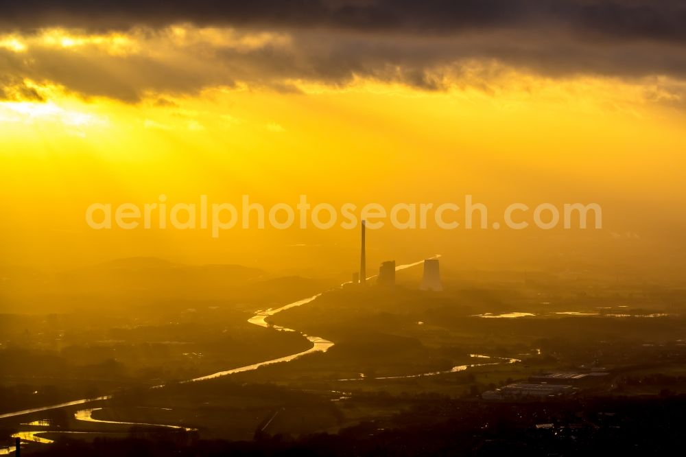 Aerial photograph Bergkamen - Power plants and exhaust towers of the coal thermal power plant of STEAG coal power plant against the light at sunset on the cloudy horizon in Bergkamen in North Rhine-Westphalia