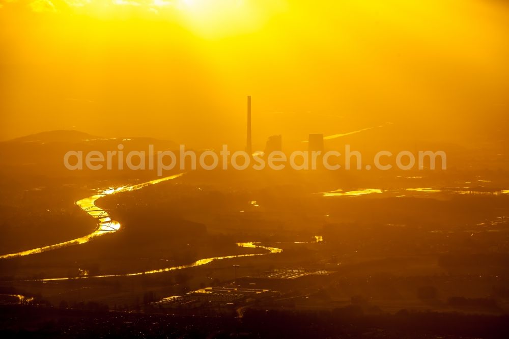 Bergkamen from above - Power plants and exhaust towers of the coal thermal power plant of STEAG coal power plant against the light at sunset on the cloudy horizon in Bergkamen in North Rhine-Westphalia