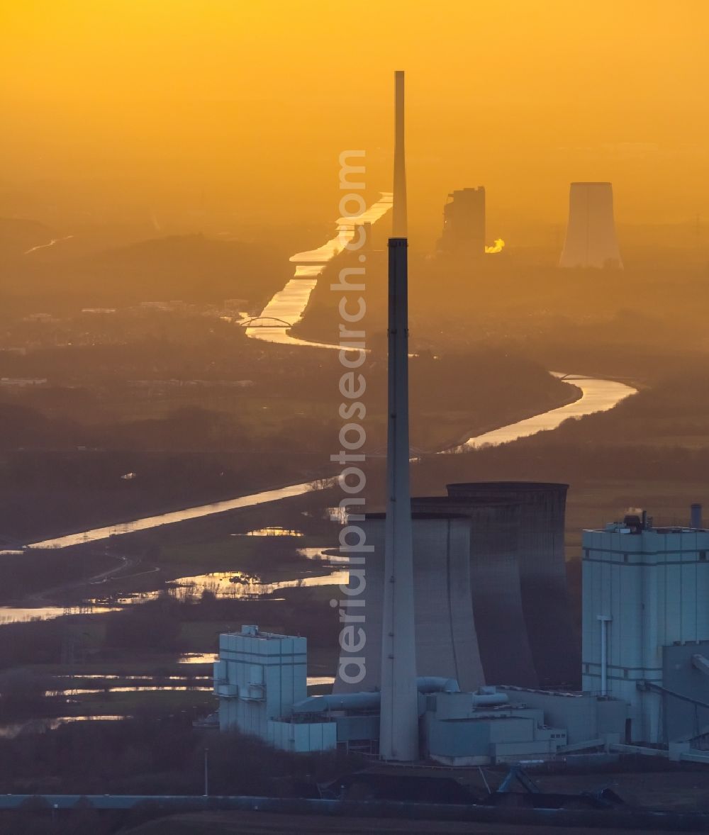 Werne from above - Power plants and exhaust towers of coal thermal power station Gersteinwerk of RWE Power in Werne in the state of North Rhine-Westphalia. The STEAG power plant of Bergkamen is visible in sunset in the background