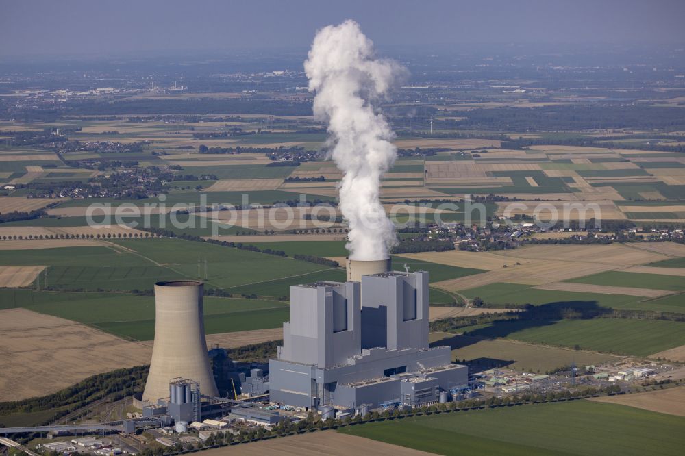 Grevenbroich from above - Exhaust smoke plumes from the power plants and exhaust towers of the coal-fired combined heat and power plant RWE Power AG Kraftwerk Neurath on Energiestrasse in the district of Neurath in Grevenbroich in the federal state of North Rhine-Westphalia, Germany